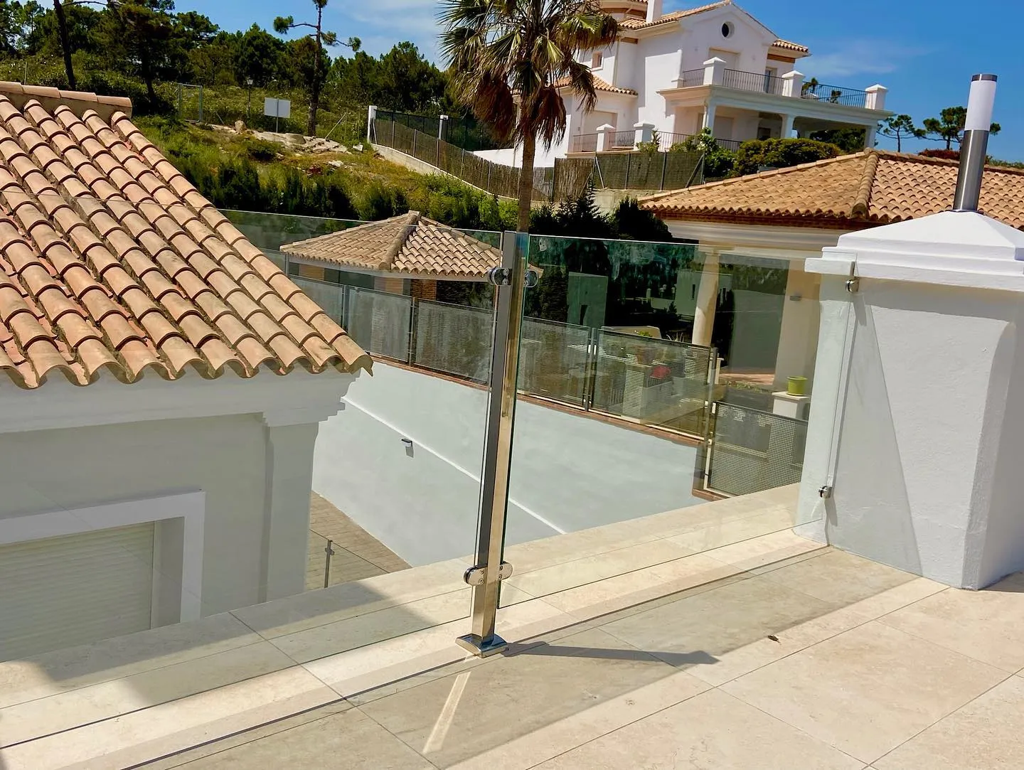 Glass balustrade with steel posts on a villa terrace